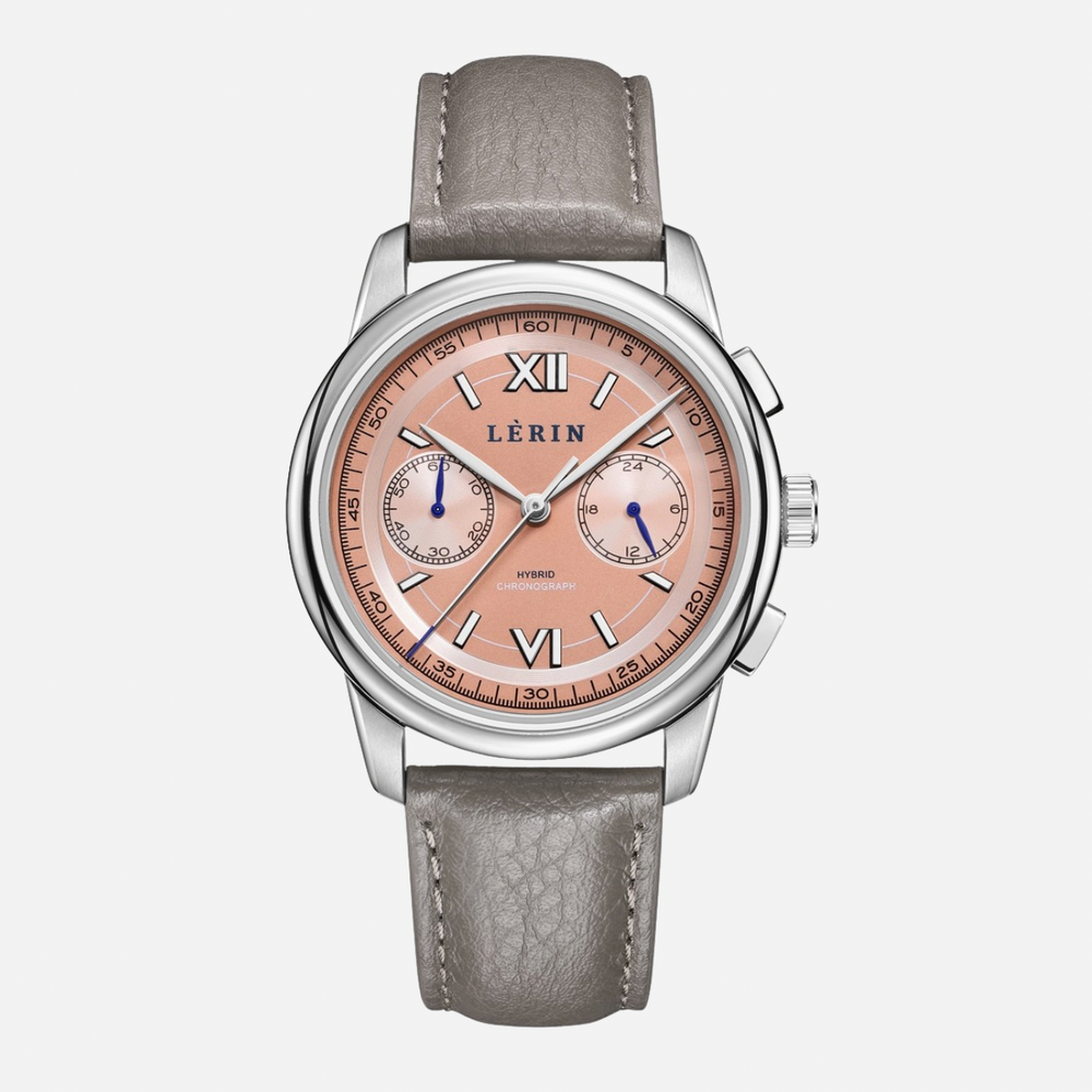 A LERIN watch featuring a round silver stainless steel case, a peach-pink dial with Roman numerals and two sub-dials, and a textured light gray leather strap, shown against a light gray background.